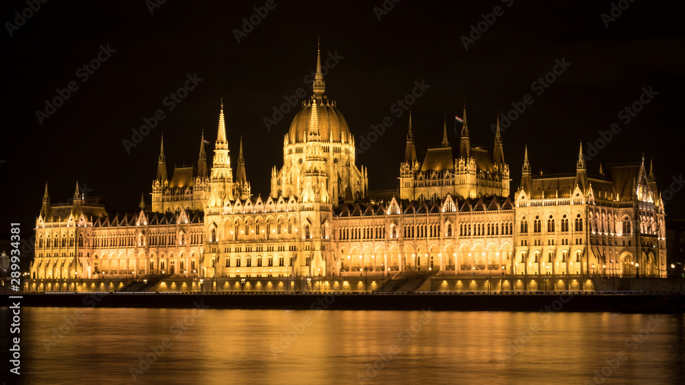 Hungarian Parliament at night on the bank of Danube river