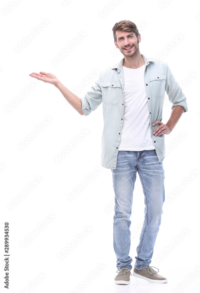 in full growth. successful young man showing on copy space. in full growth. successful young man showing on copy space.