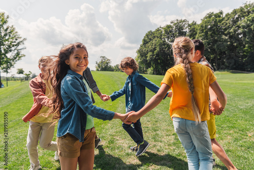 Quadro su tela selective focus of happy multicultural kids holding hands
