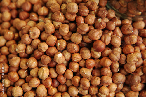 Hazelnuts without shells. Background of many new crop nuts