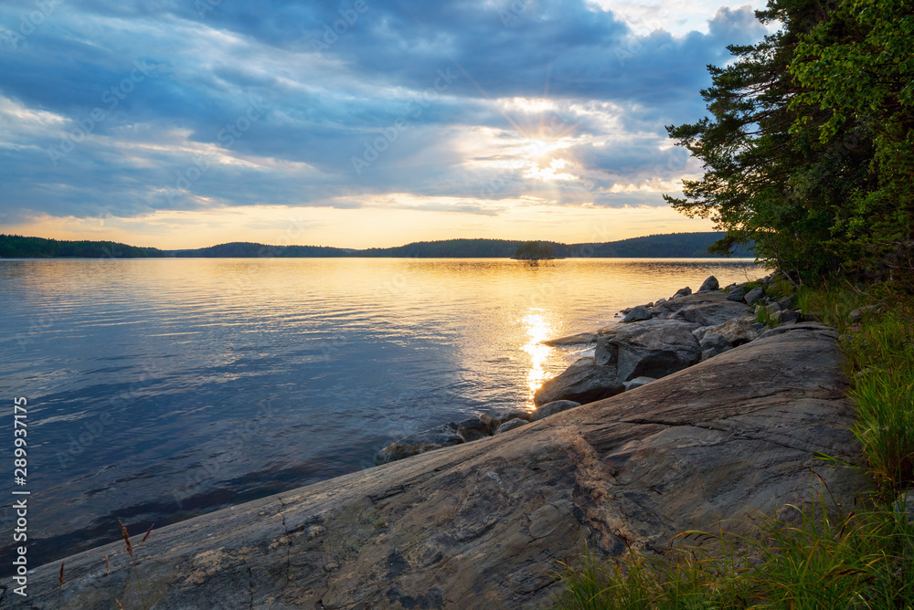 Picturesque sunset on the shore of the island on lake Ladoga .