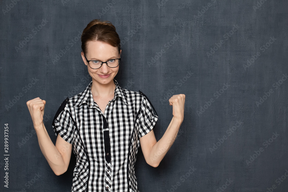 Portrait of satisfied girl showing hooray gesture with fists Portrait of satisfied girl showing hooray gesture with fists