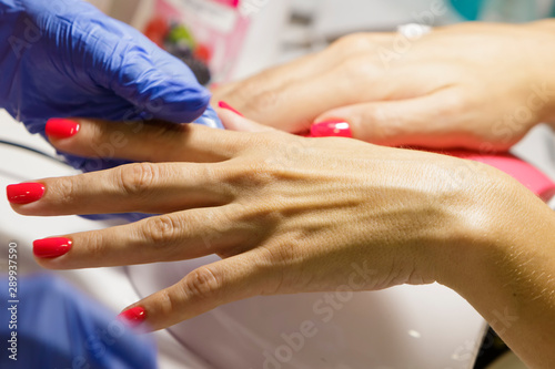 Female hand with manicure in the salon.