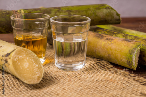 Cachaça is the name of a typical alcoholic drink produced in Brazil maked with sugarcane. Traditional drink from Brazil on wooden table