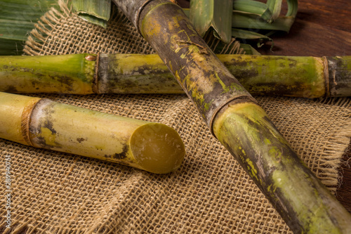 Cachaça is the name of a typical alcoholic drink produced in Brazil maked with sugarcane. Traditional drink from Brazil on wooden table