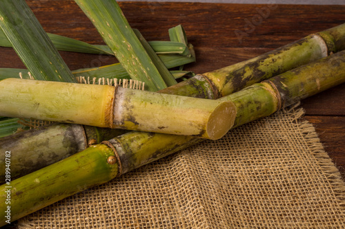 Cachaça is the name of a typical alcoholic drink produced in Brazil maked with sugarcane. Traditional drink from Brazil on wooden table