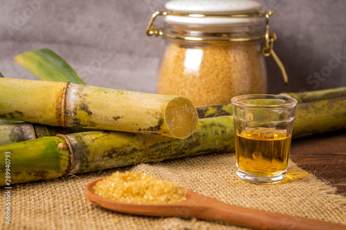 Cachaça is the name of a typical alcoholic drink produced in Brazil maked with sugarcane. Traditional drink from Brazil on wooden table