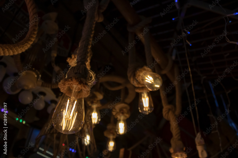 Lamps hanging on rope, brown rope and yellow light