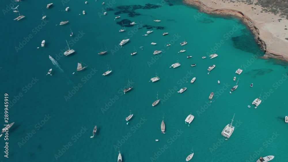 Aerial View of many yachts in a bay on Formentera island. Cala Saona bay drone footage. Yachting in the Balearic islands Aerial View of many yachts in a bay on Formentera island. Cala Saona bay drone footage. Yachting in the Balearic islands