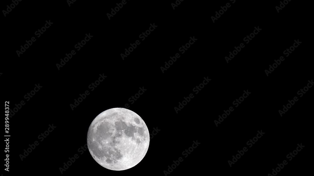 Full Moon Moves in the Night Sky with no clouds. Close up, time lapse. The mystical moon moves from bottom to top. Moonlight Shines in the black night sky. Full Moon Moves in the Night Sky with no clouds. Close up, time lapse. The mystical moon moves from bottom to top. Moonlight Shines in the black night sky.