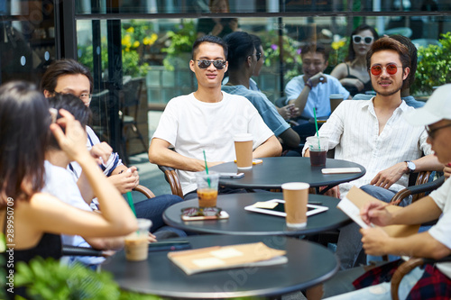 young asian adults relaxing in coffee shop