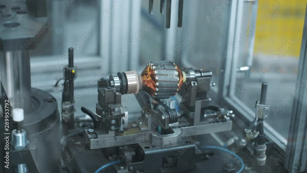 Testing electric motor at manufactory. Engineer testing finished products