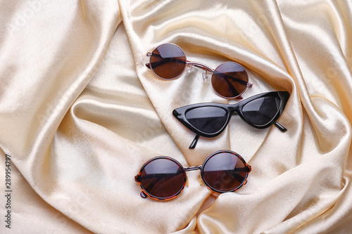 Photos Different stylish sunglasses on color background