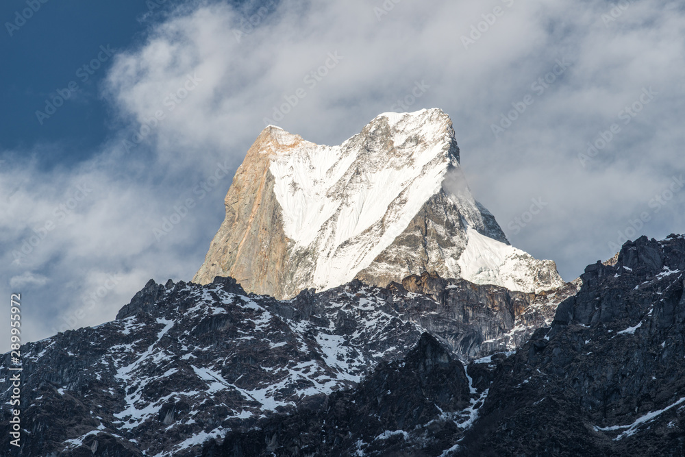 Obraz premium The upper summit of Machhapuchhre mountain (Mt.Fish tail) the holy mountains in Hindu religion believed it the rest place of God Shiva view from Dovan village, Nepal.