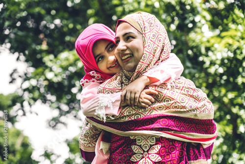 Fotografie Portrait of happy lovely family arabic muslim mother and little muslim girls chi