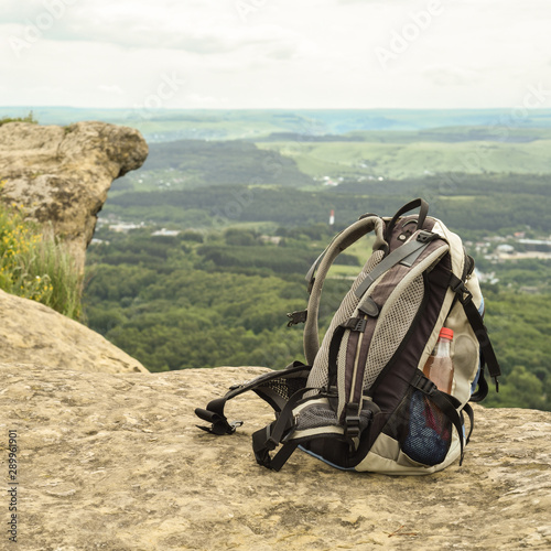 Hipster hiker tourist backpack on background nature in mountain, blurred panoramic landscape, traveler relax holiday concept, view planning wayroad in trip vacation, travel adventure. photo