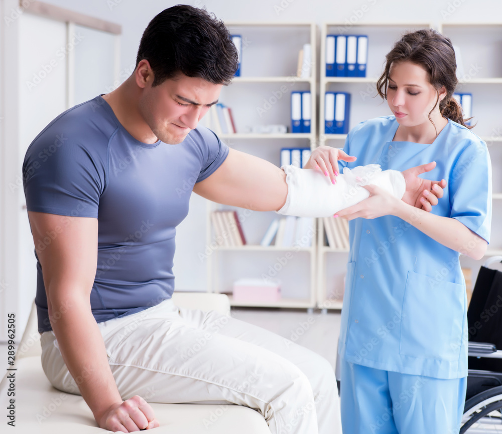 Doctor and patient during check-up for injury in hospital Doctor and patient during check-up for injury in hospital
