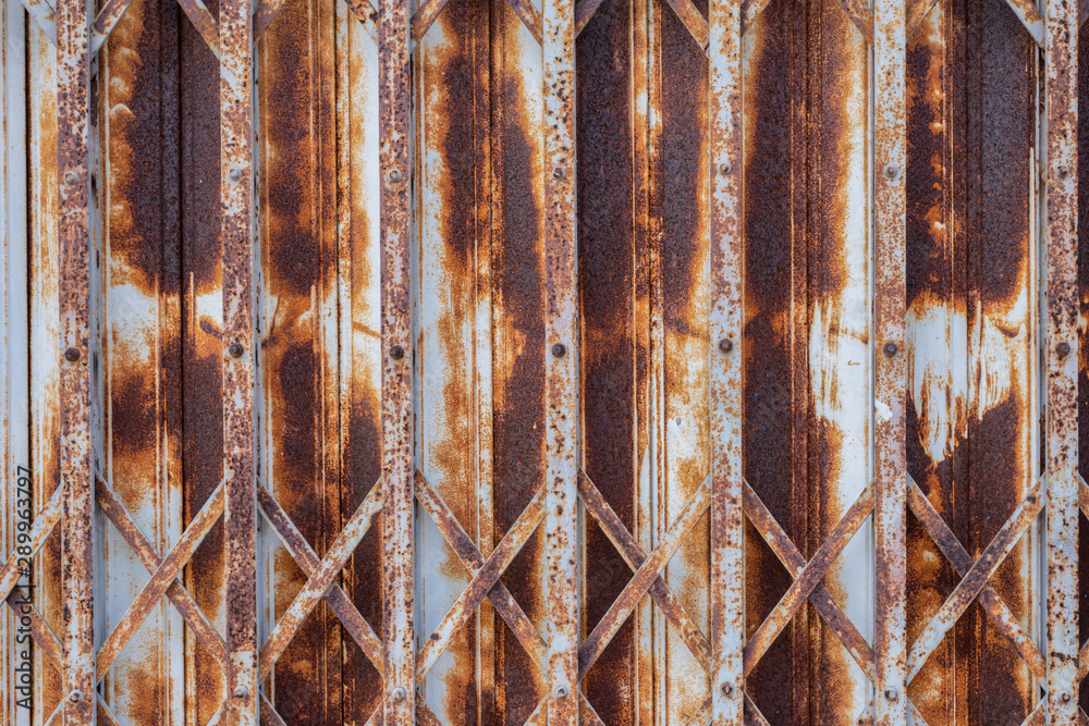 Grunge steel foldable door.Close up of old rusted door in vintage style use for texture and background.