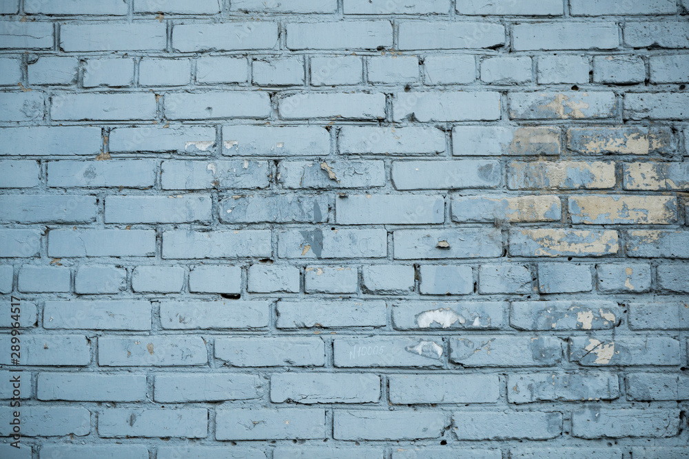 Texture of an old paint covered brick wall. Background image of an abandoned brick wall with painted over paint Texture of an old paint covered brick wall. Background image of an abandoned brick wall with painted over paint