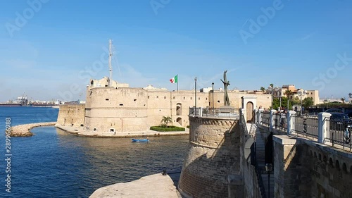 The Aragonese Castle in Taranto, South of Italy on the Industrial Site Arcelor Mittal Background in a sunny day photo