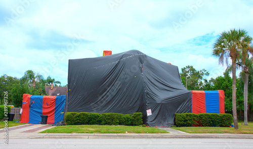 Εκτύπωση καμβά Tented large two story house with palm trees in the yard that is tented and treated to kill termites and other bugs also known as structural fumigation