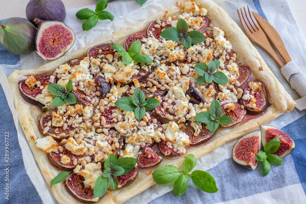 home made tart with figs and cheese on a table