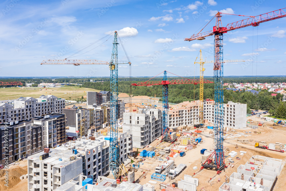 aerial panoramic image of city construction site against blue sky background