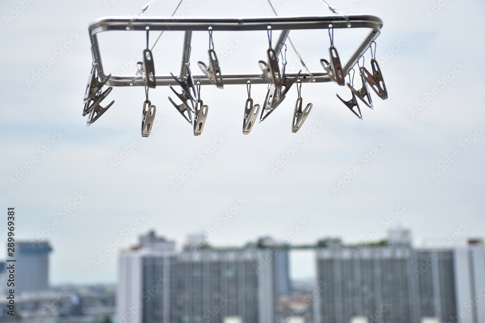 Clothespin hanging on a skyscraper background. Clothespin hanging on a skyscraper background.