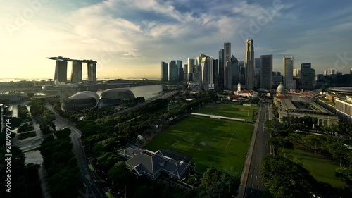 Aerial view of Singapore skyline. Included in this view are the Marina Bay Sands complex, the Padang, The Singapore Cricket Club and Financial District skyline in background. Sunrise to day time-lapse photo