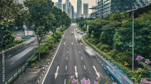 Rush hour traffic with Singapore skyline in background. Slow pan up time lapse of rush hour traffic on the Nicoll Highway with the high rise skyline in the background photo