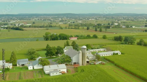 Aerial View of Rural Farm House in Pennsylvania with Barn, Silos, Corn Fields