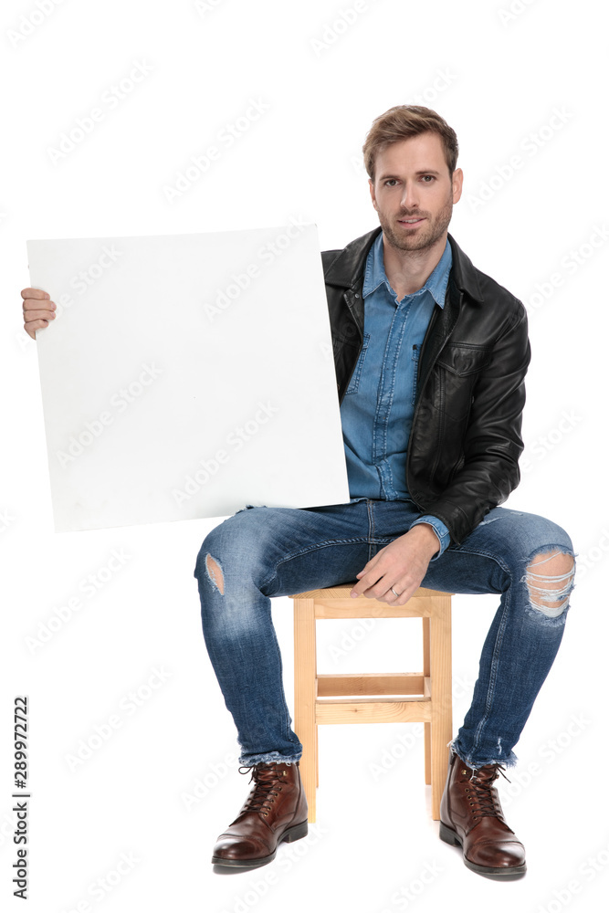 seated man holding a blank billboard on one hand seated man holding a blank billboard on one hand