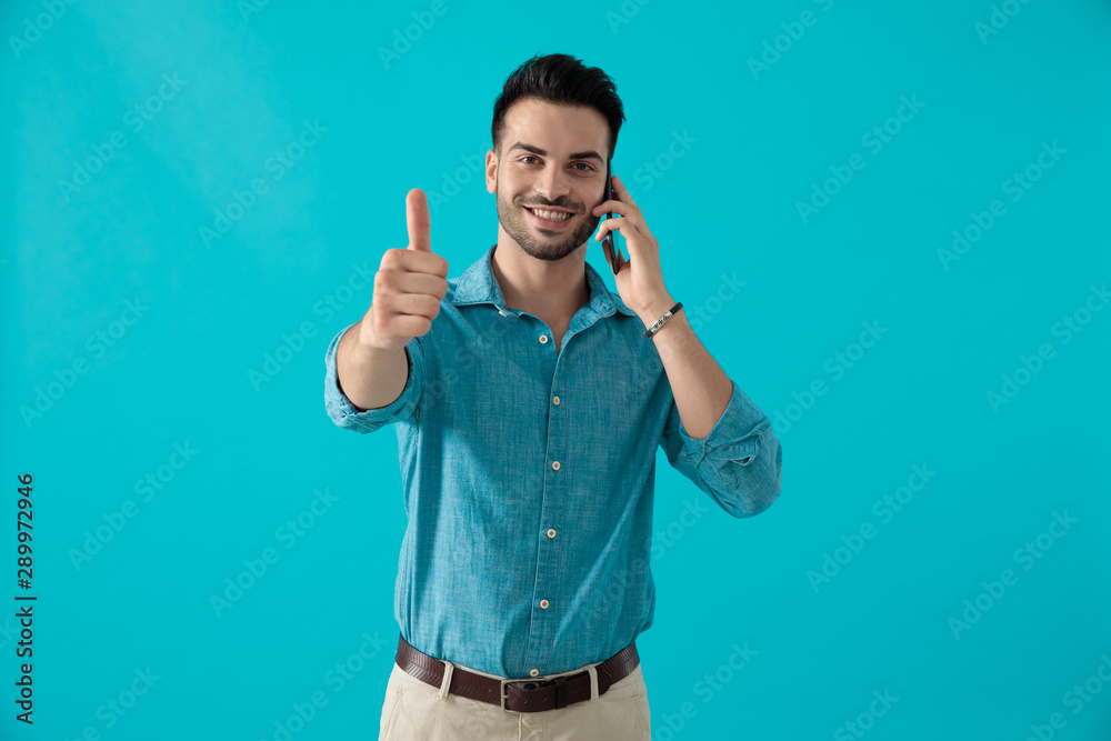 man speaking at phone with thumbs up gesture man speaking at phone with thumbs up gesture