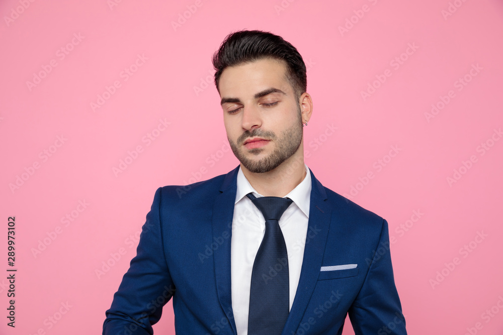 handsome young man standing on pink background handsome young man standing on pink background