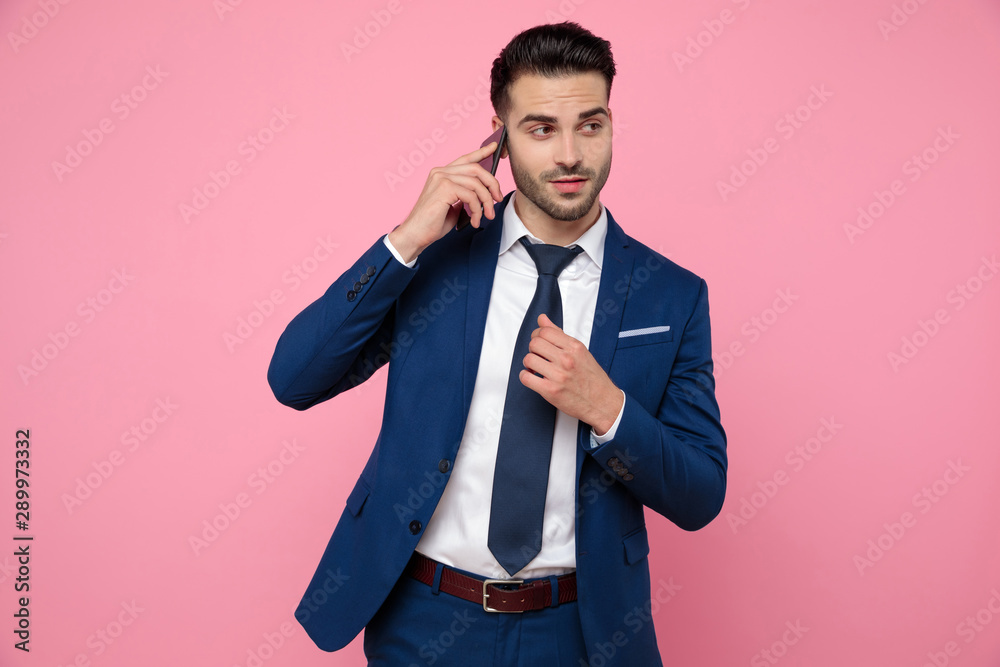 smart casual man wearing navy blue suit and talking on the phone