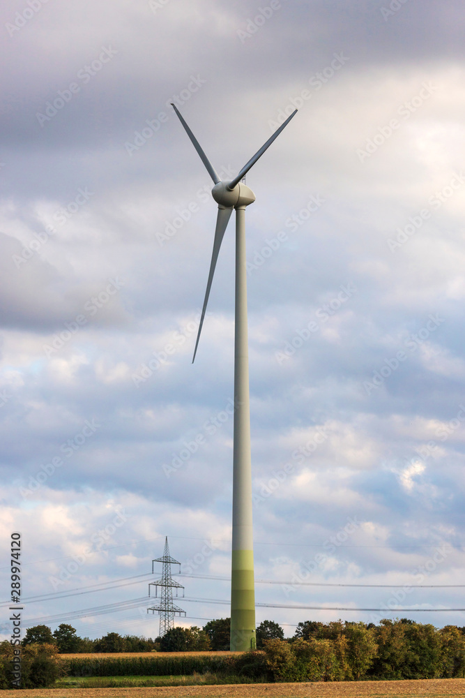 a modern wind turbine in front of a cloudy sky