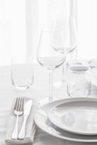 Table set with silver cutlery and glassware . Dinning concept background. Close up.