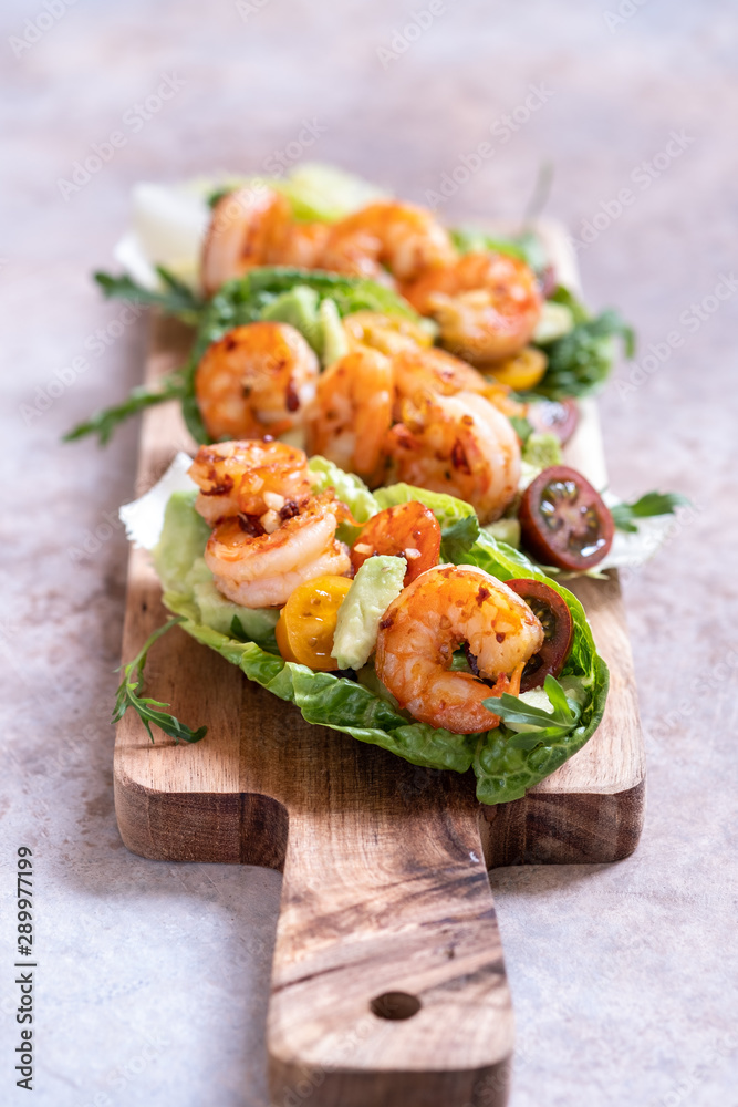 Lettuce wrapped Shrimp tacos with fresh tomato, avocado and lime Lettuce wrapped Shrimp tacos with fresh tomato, avocado and lime