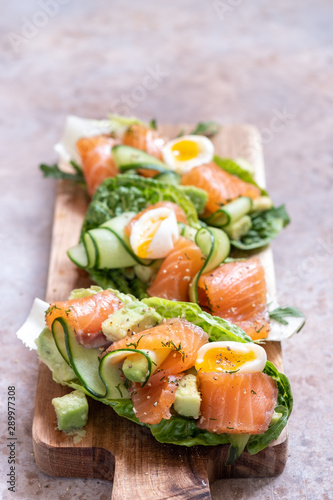 Lettuce wrapped smoked salmon tacos with fresh cucumber, avocado and quail eggs