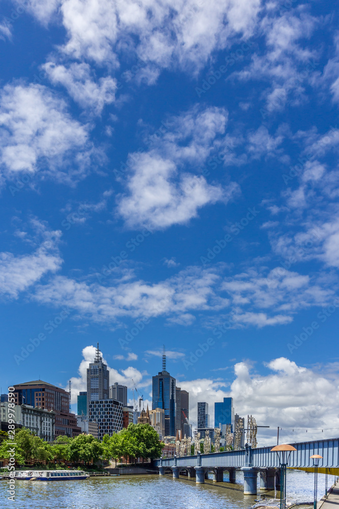 Melbourne CBD skyline and Yarra River against clear sky. Vertical orientation. Copy space.