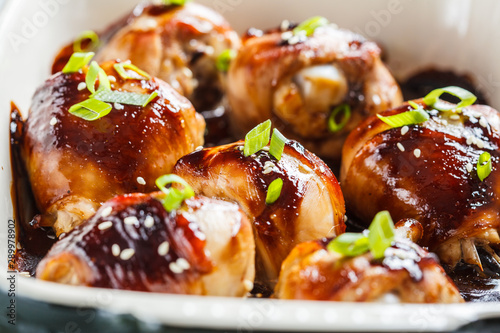 Oven-baked teriyaki chicken with green onions and sesame seeds.