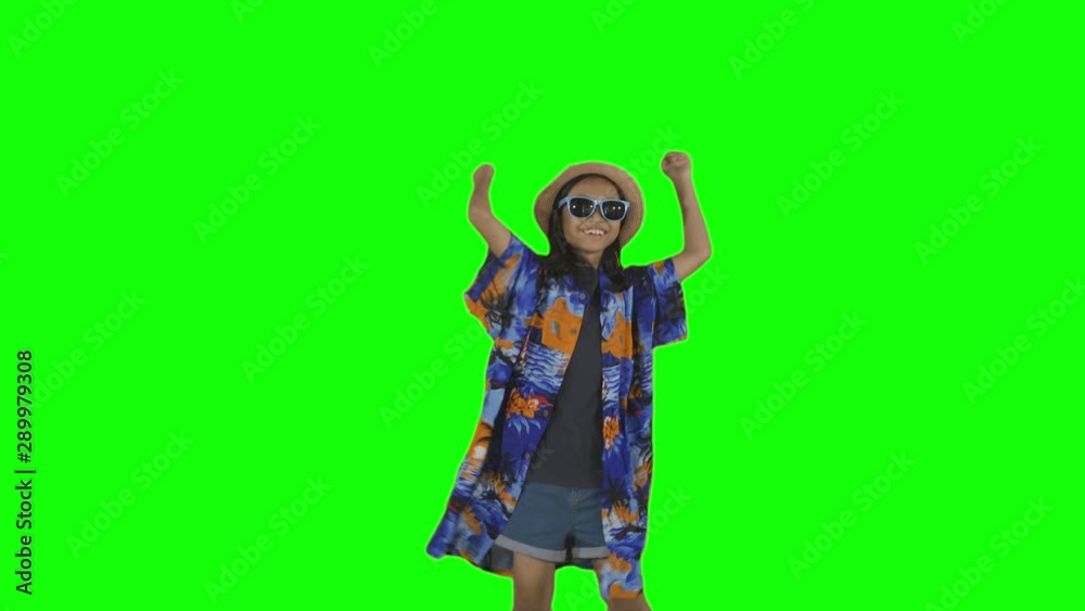 Funky little girl dancing in the studio while wearing a big clothes, hat, and sunglasses. Shot in 4k resolution with green screen background Funky little girl dancing in the studio while wearing a big clothes, hat, and sunglasses. Shot in 4k resolution with green screen background