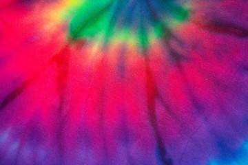 Tie dye rainbow textile fabric abstract textured . hippie and reggae style .