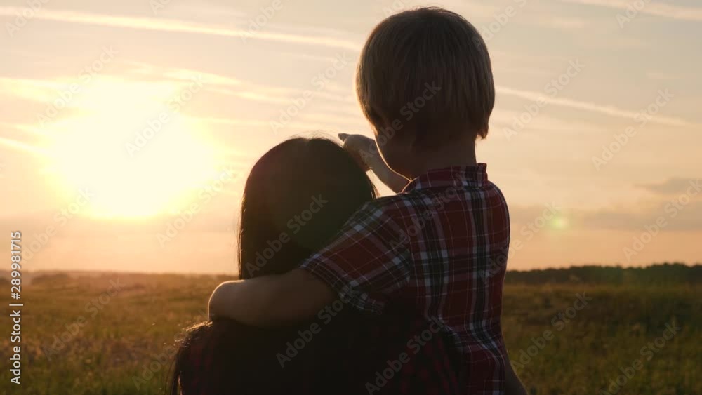 A happy family. Mom and son watching the sunset. Traveling and walking outdoors. The concept of happiness and health. A happy family. Mom and son watching the sunset. Traveling and walking outdoors. The concept of happiness and health.