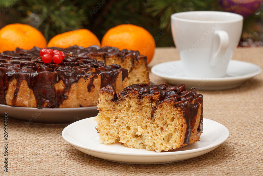 Chocolate cake and a slice of it on plate with cup of coffee. Chocolate cake and a slice of it on plate with cup of coffee.