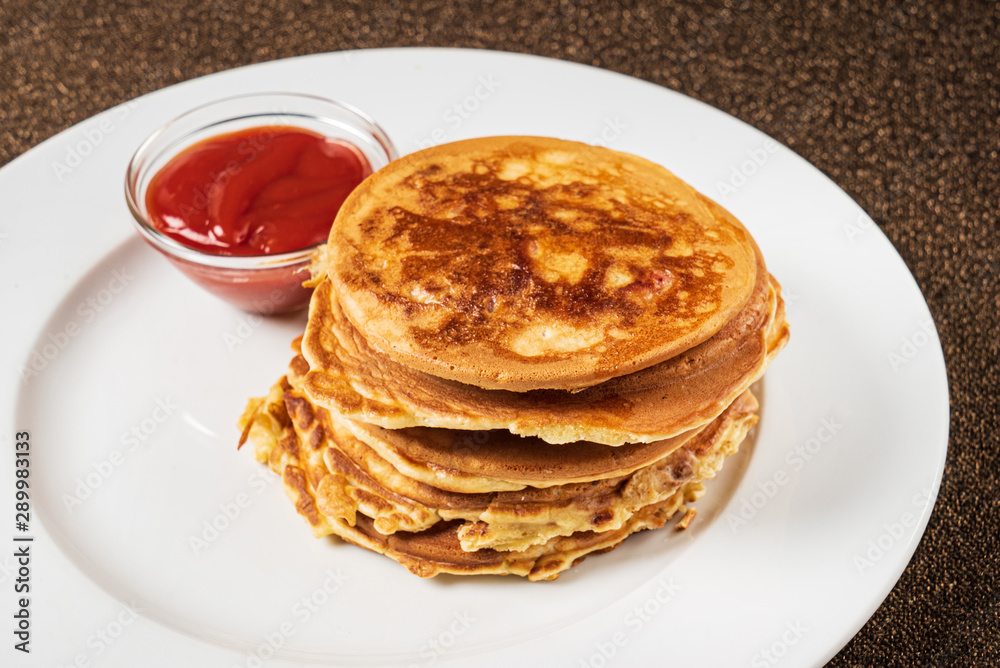 pancakes with strawberry sauce on the white plate pancakes with strawberry sauce on the white plate