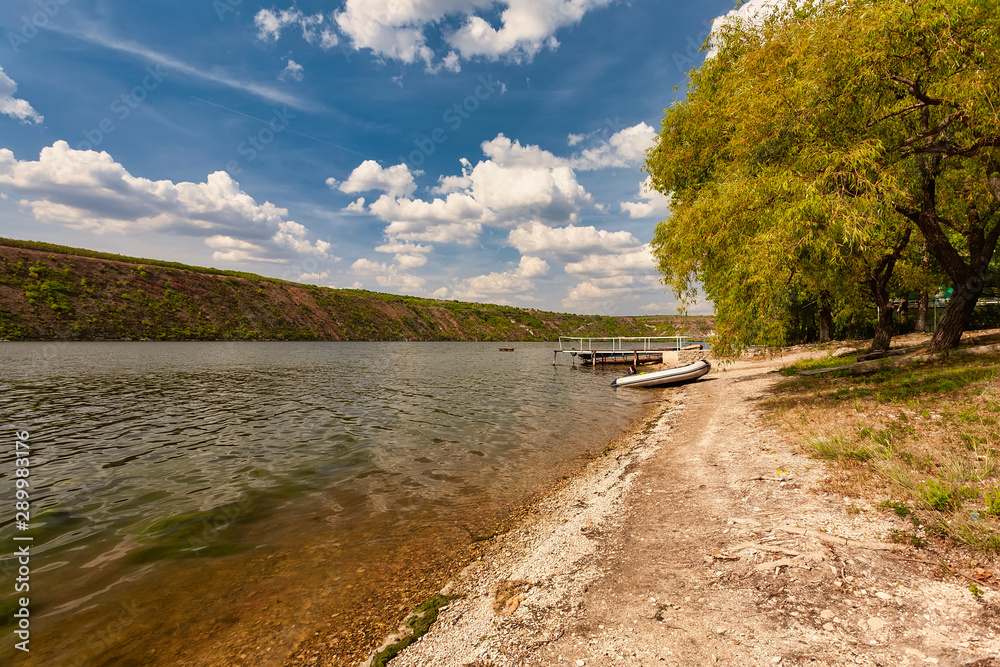 Autumn river bank with blue sky and trees