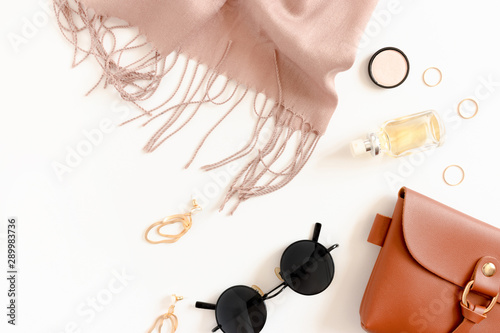 Fashion flatlay with women's cosmetics and accessories on white desk photo