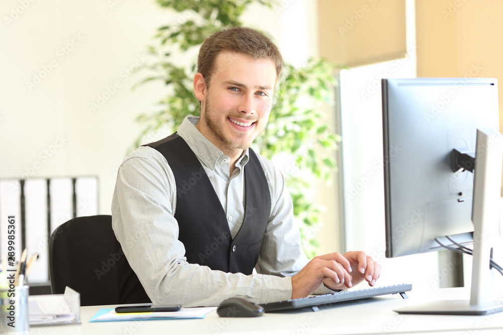 Happy executive posing looking at camera at office Happy executive posing looking at camera at office