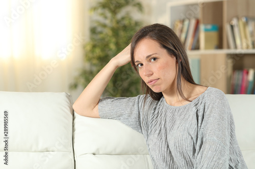 Free Download Serious woman at home looking at camera - GFXLoad